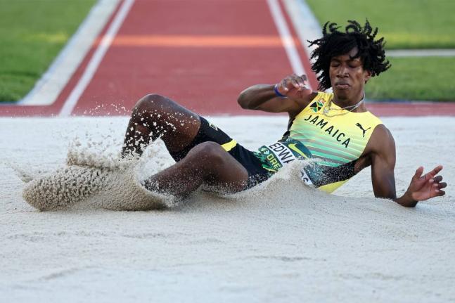 Jamaica’s Michael-Andre Edwards hits the sandpit during the triple-jump final at the World Athletics Under-20 Championships at the Hayward Field in Eugene, Oregon.