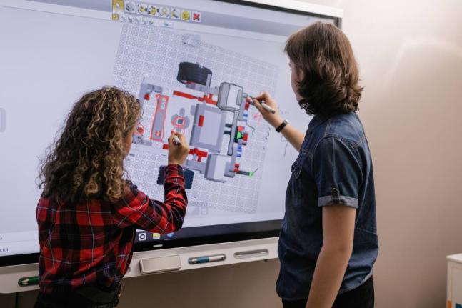 Representational image of students using smartboard in their classroom.