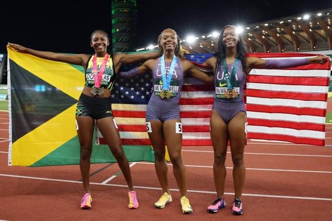 From left: Jamaica's Shanoya Douglas and United States twins, Mia and Mariah Maxwell, celebrate the medals they won during the women's 200-metre final at the World Athletics Under-20 Championships at Hayward Field in Eugene, Oregon, yesterday. 