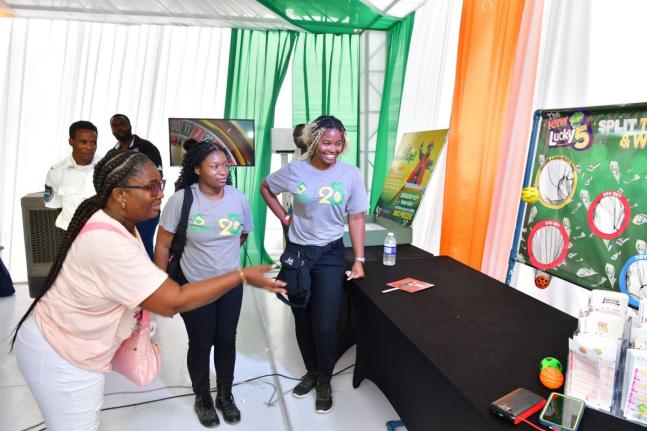 Janique Diamond tries her hand at the interactive ‘Lucky 5’ game at the Evolve booth during the MoBay Jerk and Food Festival. Evolve provided a programme of activities offering festival-goers the chance to play and win prizes throughout the day.