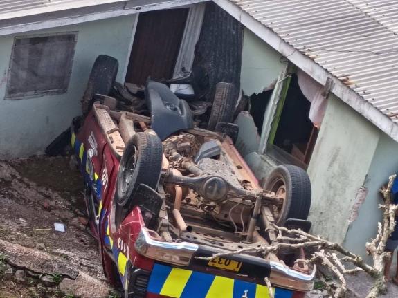 An overturned police service vehicle that ran off the road and crashed into a house in Clarendon on August 10, 2026.