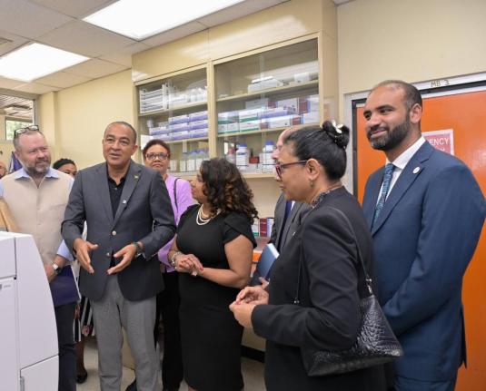 Minister of Health and Wellness Dr Christopher Tufton (second left) speaks at the opening of CARPHA’s antimicrobial resistance regional reference referral laboratory at Hope Gardens, St Andrew. Listening are (from left) Andrew Bowden, development lead at