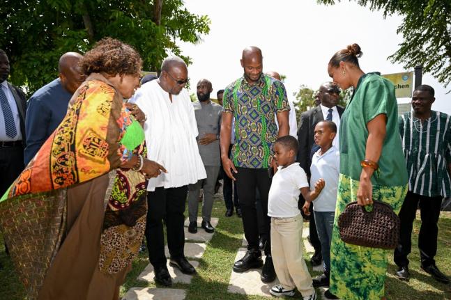 Minister of Culture, Gender, Entertainment and Sport, Olivia Grange (left), and President of the Republic of Ghana, John Dramani Mahama (second left), meet Jamaican sprint legend, Asafa Powell (third left), and members of his family during a visit to Sevil