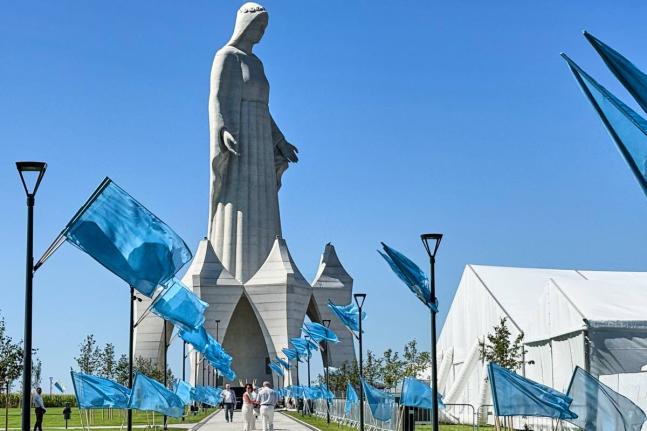 Flags wave in the wind in front of an enormous statue of the Virgin Mary that is believed to be Europe’s tallest during the inauguration in the village Konotopie, Poland.