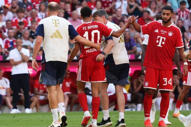 Bayern Munich’s Jamal Musiala (centre) leaves the pitch due to an injury during a pre-season  match between FC Bayern Munich and RB Leipzig in Munich, Germany, Saturday, August 15, 2026. 