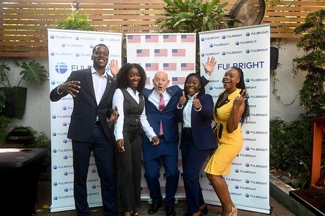 US Embassy Public Affairs Attaché Mike Lavallee (centre) celebrates with the 2026 Fulbright awardees (from left) Abishua Johnson, Davia Findlotor, Joelle Hanson, and Jervian Johnson.