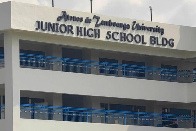 A guard secures an area at the junior high school building on the Ateneo de Zamboanga University campus following a shooting incident in Zamboanga, southern Philippines Tuesday, Aug. 18, 2026. (AP Photo)