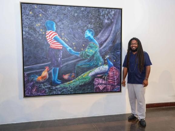 
Visual Artist, Richard Nattoo next to his creation, The Majician’s Arrival. 