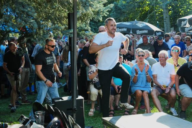 Ulrich Sigmund, the top candidate for the ‘Alternative for Germany’ (AfD) party in the state elections in Saxony-Anhalt, enters the stage at a campaign barbecue hosted by the party in Moeser, Germany, August 13.