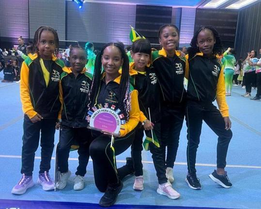 Sherri-Lee Smith, gymnastic coach at First Dance, Montego Bay (centre), is flanked by from left; Alexia Allen, MaCherie Wynter, Kaelei Palmer, and Jenneilia Grant walk the stage to represent Jamaica at the opening ceremony of the Yamilet Pena Gymnastics Cl