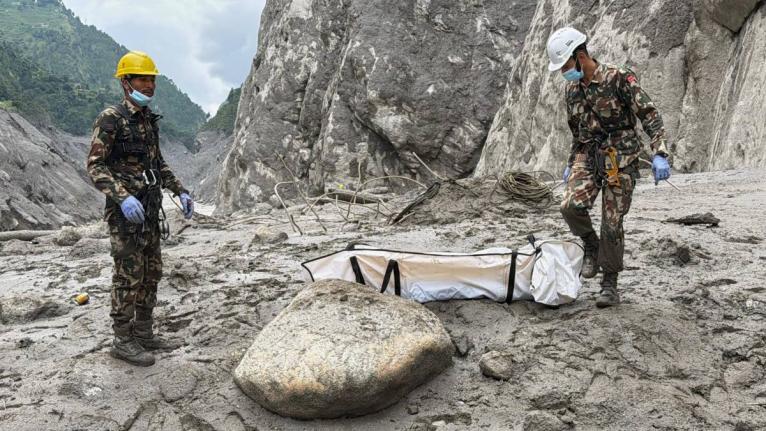 Nepal Army soldiers carry a body of a worker recovered from the site of a hydropower project in Upper Trishuli, Nepal, on Tuesday. - AP photo