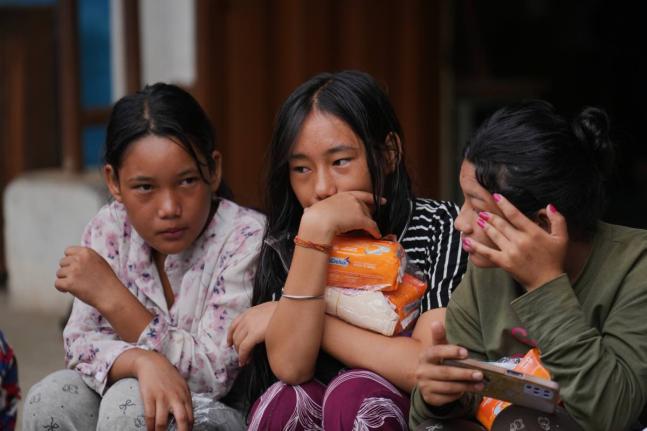 Displaced girls sit at a school converted into a temporary shelter for displaced residents in residents in Bidur, in Nepal’s Nuwakot district, on Tuesday, September 1.