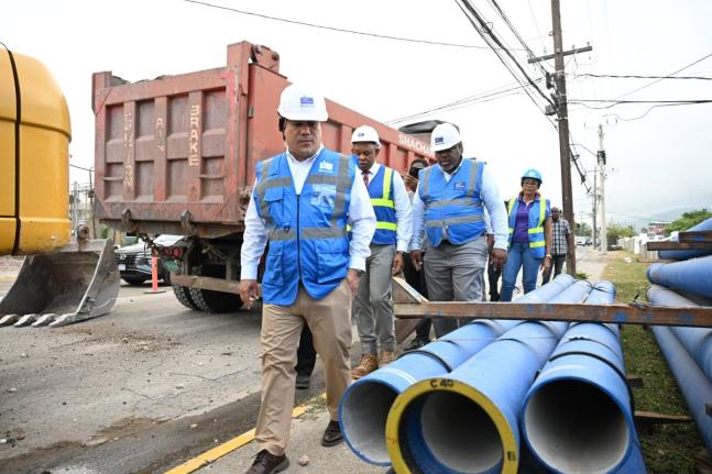 
Minister of Water, Environment and Climate Change, Matthew Samuda (foreground), along with personnel from the National Water Commission (NWC), tours the Monroe Road and Wellington Drive pipeline and sewerage expansion works in St Andrew on September 1.