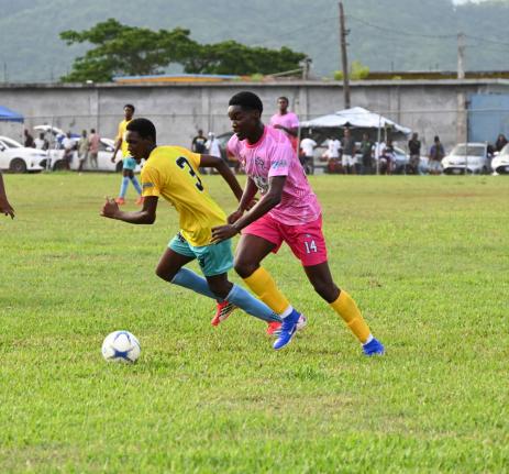 
Rusea’s High School’s Mikkel Hason (right) dribbles while being closely attended by Little London’s Damani Smith during their ISSA daCosta Cup clash at the Little London playfield yesterday.