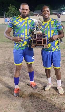 McKay Security’s Rohan Williams (left) and Akeem Higgins pose with the Kingston and St Andrew Business House Football Association Knockout Trophy after defeating Seprod 2-0 at Constant Spring on Saturday.