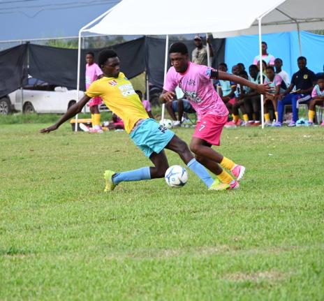 Rusea’s High’s Maliek Headed (right) skips by the challenge of Little London High’s Clifton Cameron during their ISSA daCosta Cup first-round football game at the Little London playing field on Saturday.