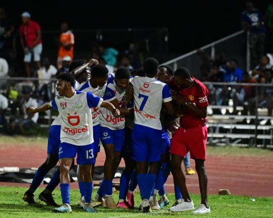 Hydel High’s Ronaldo Barrett (obscured) celebrates a goal with teammates during a Manning Cup Game against Jamaica College at the Ashenheim Stadium in St Andrew, Jamaica on Saturday, November 4, 2023. 