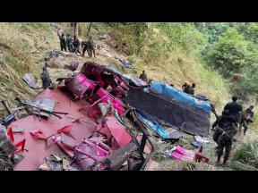 Credit: Prasanna Pathmasiri Soldiers and rescue workers stand by the debris of a passenger bus after it plunged into a precipice in Wellawaya, Sri Lanka yesterday.