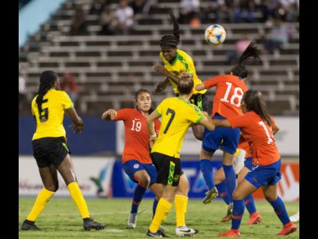 Jamaican striker Khadija Shaw (top) gets high to head to goal during the first international friendly against Chile at the National Stadium on Thursday, February 28, 2019. The Reggae Girlz won 1-0. File