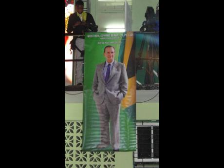 Credit: Paul H. Williams A poster with the image of former prime minister, Edward Seaga, emblazoned on it, at the recent Revival table set up in his honour inside the community centre in Tivoli Gardens.