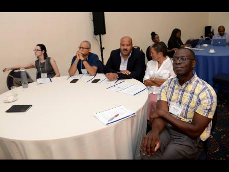 Participants look on during presentations at the African-Caribbean Cancer Consortium Conference at The Jamaica Pegasus last Sunday. The conference was staged to look at cancer in people of African ancestry, because they are more affected by the disease than other races.  