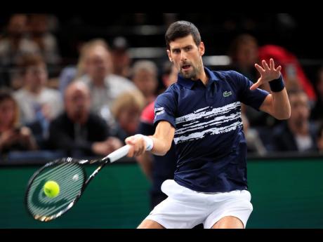 Credit: Michel Euler Serbia’s Novak Djokovic returns the ball to Greece’s Stefanos Tsitsipas during their quarter-final match of the Paris Masters tennis tournament yesterday. Djokovic won 6-1, 6-2.