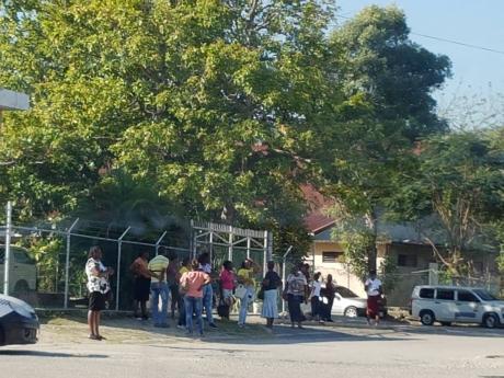 A group of approximately 15 persons gathered outside the Westgreen Health Centre in Catherine Hall, Montego Bay, on Thursday, March 26.