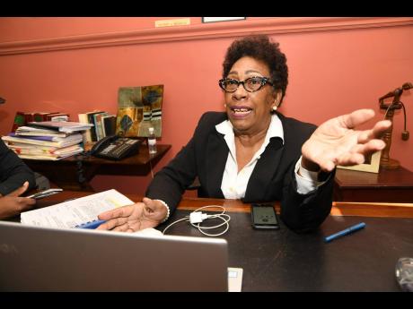 Valerie Neita-Robertson, QC, speaks to members of the media after listening to the Court of Appeal judgment in relation to  Vybz Kartel and his co-accused Shawn ‘Shawn Storm’ Campbell, Kahira Jones and Andre St John. The decision was handed down via a conference call between the panel of three judges, prosecutors and the attorneys for the four men. Neita-Robertson was speaking from her Duke Street offices in Kingston yesterday. 