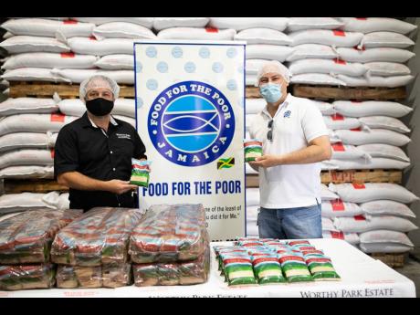 Gordon Clarke, managing director and chief executive officer, Worthy Park Estate, shares an elbow bump with Food For The Poor, Director, Craig Moss-Solomon, in celebration of the donation by Worthy Park Estate to Food For The Poor’s COVID-19 relief.