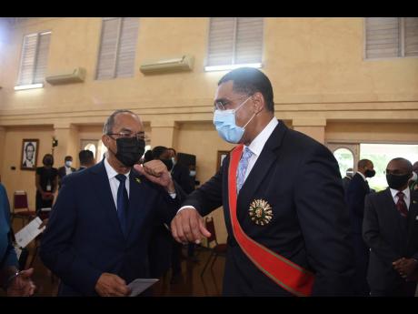 Prime Minister Andrew Holness and Deputy Prime Minister and Minister of National Security Horace Chang leading by example by observing the COVID-19 protocols as they greet each other at the swearing-In ceremony on Monday.