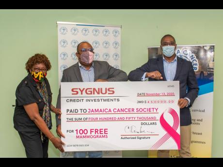 Credit: Contributed From left: Elve Passley, administrative officer, Jamaica Cancer Society (JCS); Michael Leslie, acting executive, JCS; and David Cummings, vice-president and head, Real Estate & Project Finance at Sygnus, hold the symbolic cheque which was donated to the J