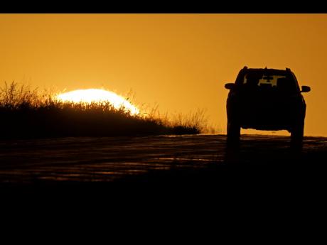 AP
In this October 1, 2020 photo, a motorist drives into the sunrise in Kansas City.