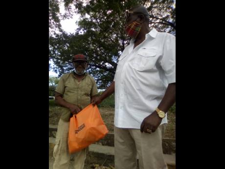Horace Noble, 80, receives a gift package from ex-cop Hornet Williams.