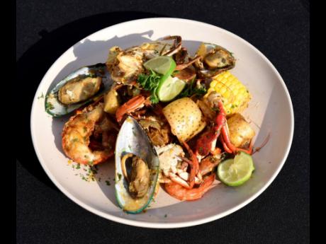 A closer look at the seafood extravaganza – lobster, shrimp, mussels, crab, Irish potatoes and sweetcorn simmered in a famous citrusy sweet and spicy sauce. 