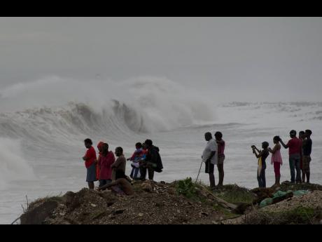 Credit: File
People in Kingston watch as a storm approaches in October 2016. It is the job of the ODPEM to ensure Jamaica is prepared for and able to cope with natural disasters.