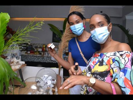 Safety first: Masks on, Toni Hibbert (left) and Marsha Nelson indulge in some well-deserved retail therapy.