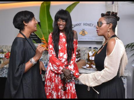 Kerry-Ann Clarke (left) engages in exciting conversation with the fabulous dressed Karlene Kellond (centre) and Racquel Jenkins. 