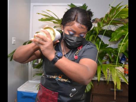 Mixologist Shakeria Johnson shakes things up to make a passion fruit margarita.  