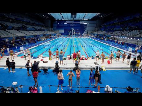Athletes exercise during a swimming training session at the Tokyo Aquatics Centre at the 2020 Summer Olympics in Tokyo, Japan, yesterday.