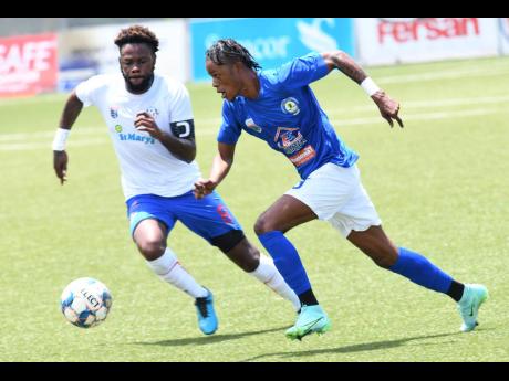 Portmore United's Ricardo Morris (left) battles for ball possession with Mount Pleasant's Daniel Green during a Jamaica Premier League game at the UWI-JFF Captain Horace Burrell Centre of Excellence on Sunday, August 8.