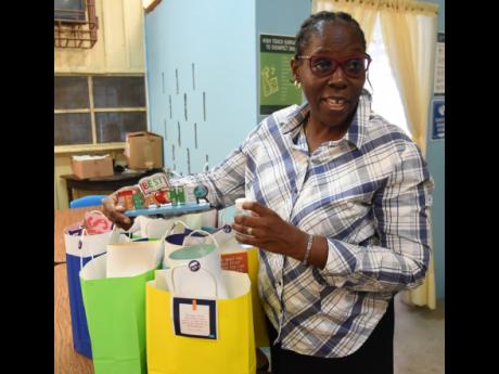 Josette Doyley, principal of Spring Gardens Primary School in St Thomas, preparing gift bags for her teachers as they return to school.