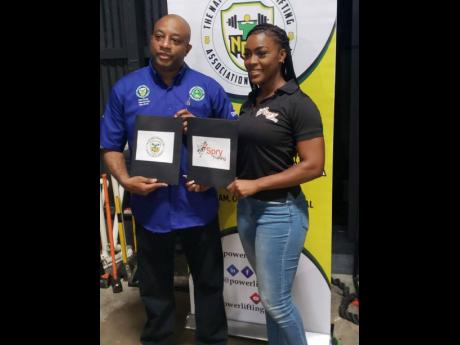 Credit: Contributed
Michael Blair (left), President, National Powerlifting Association of Jamaica (NPAJ) and Kenesha Miller, Operations Manager, Spry Training Gym, display contracts after recently affixing their signature to partnership agreements at Spry Training gym.