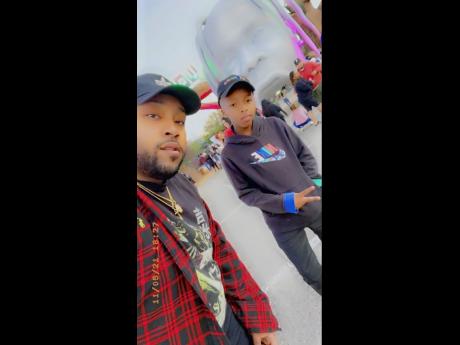 This photo provided by Taylor Blount shows Ezra Blount (right), and his father, Treston Blount, (left), posing outside the Astroworld music festival in Houston. Both were injured later at the concert during a crowd surge. Ezra is the youngest person to die