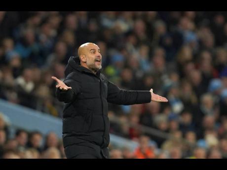 Manchester City’s head coach Pep Guardiola reacts during the English Premier League match between Manchester City and Leeds United at Etihad stadium in Manchester, England, on Tuesday.
