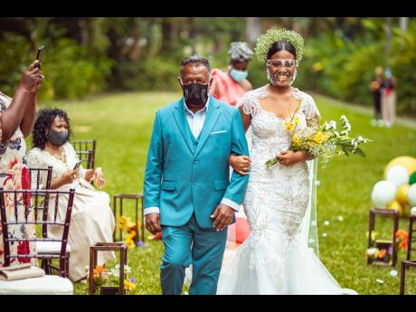 Denton Copeland walks his daughter, the blushing bride Mercy-Ann Copeland, down the aisle.