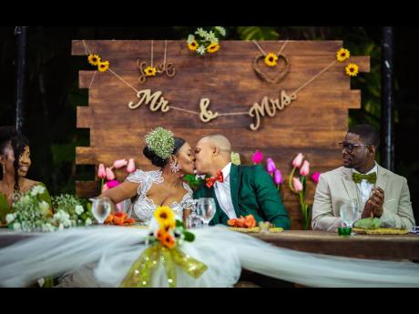 The Robinsons are caught in a kiss during the reception. 