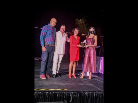 Credit: Contributed Juan Carlos Fernandez-Friera (second left), vice-president of sales and marketing at Ocean by H10 Hotels, and Tanesha Clarke (second right), sales and marketing director of Ocean Coral Spring, present the first-place award to Kameika Lewis, reservations ma