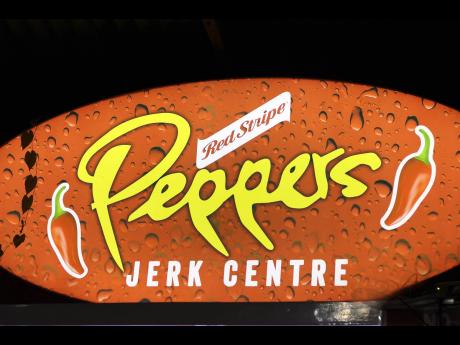 Credit: Stephanie Lyew A well-lit sign with red hot peppers, which can be seen from a distance, lures passersby from the roadway of Duke Street, Falmouth.