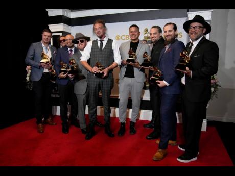 Credit: AP Soja, winners of the award for best reggae album for "Beauty in the Silence," pose in the press room at the 64th Annual Grammy Awards at the MGM Grand Garden Arena.