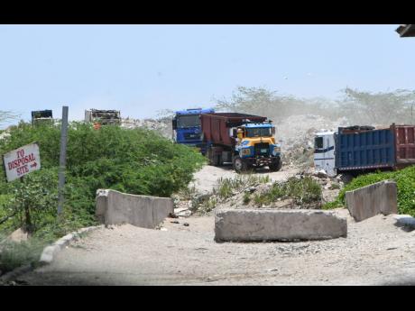 Garbage trucks drive along a road ini the Riverton City dump after workers, through their union, issued a 72-hour threat to the NSWMA on Monday. The threat was withdrawn on Tuesday.